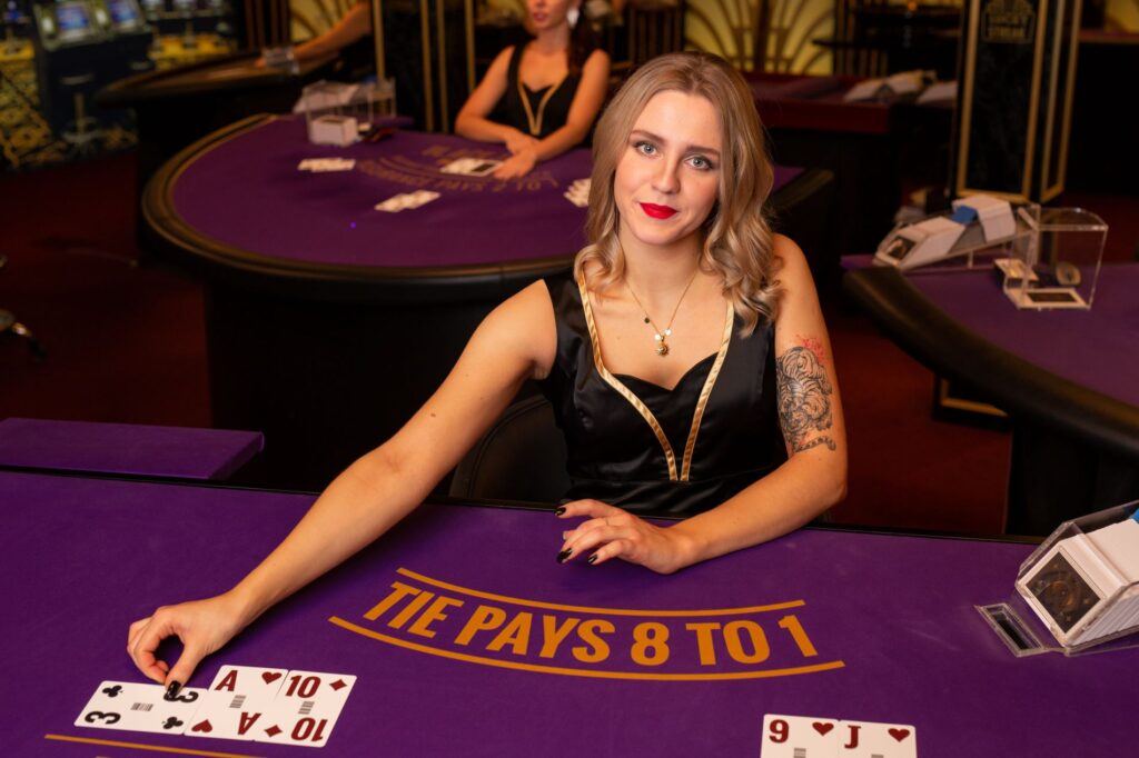 Dealer live casino membagikan kartu baccarat